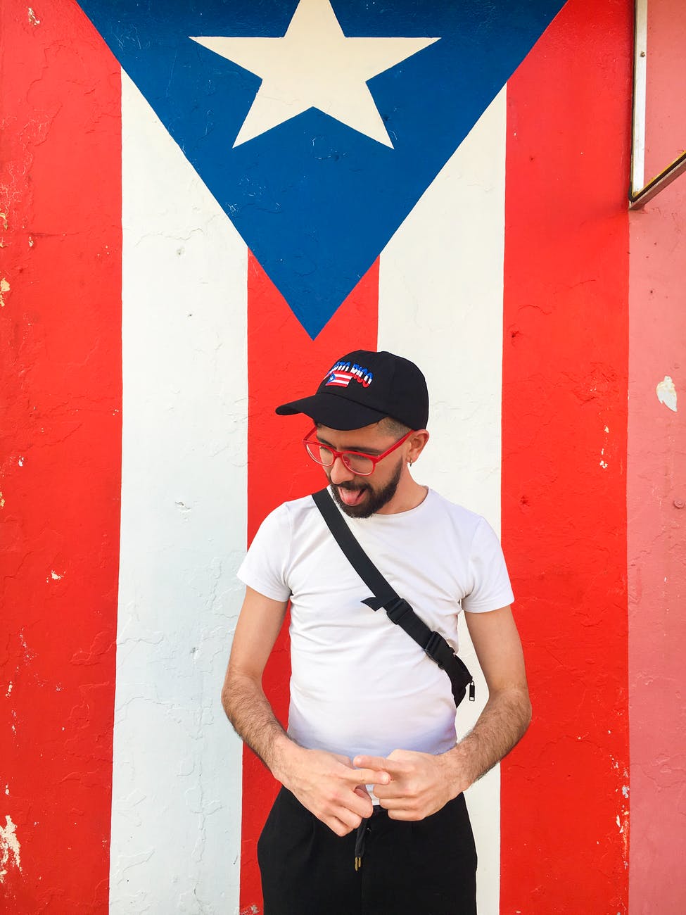 man standing near puerto rico flag